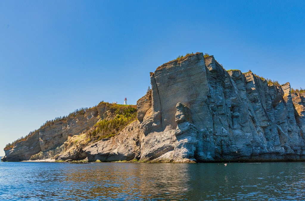 The cliffs of Land's End and Cap-Gaspe lighthouse,Forillon National Park, Quebec.
